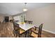 Dining area open to living room with natural light and wood-look flooring at 546 Orangewood Dr, Dunedin, FL 34698