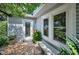 Charming home featuring a decorative glass front door, stone bench and blooming flowers at 546 Orangewood Dr, Dunedin, FL 34698