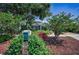Charming home with blooming bushes, brick mailbox, and mature trees creating a picturesque setting at 546 Orangewood Dr, Dunedin, FL 34698