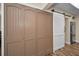 Hallway featuring hardwood floors, a white sliding door, and storage cabinets at 546 Orangewood Dr, Dunedin, FL 34698