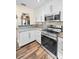 Contemporary kitchen with white cabinets, stainless steel appliances, and stylish countertops at 546 Orangewood Dr, Dunedin, FL 34698
