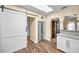 Modern kitchen with stainless steel appliances, wood-look flooring, and natural light at 546 Orangewood Dr, Dunedin, FL 34698