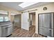 Well-lit kitchen with stainless steel appliances, custom cabinets, and wood-look flooring at 546 Orangewood Dr, Dunedin, FL 34698