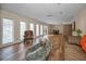 Open concept living room with plenty of natural light and wood flooring at 546 Orangewood Dr, Dunedin, FL 34698