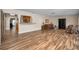 Large living room featuring wood floors and kitchen pass-through window at 546 Orangewood Dr, Dunedin, FL 34698