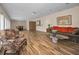 Living room with hardwood floors and access to the dining room and kitchen at 546 Orangewood Dr, Dunedin, FL 34698