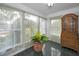 Bright sun room with large windows offering plenty of natural light and tiled floors at 546 Orangewood Dr, Dunedin, FL 34698