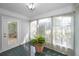 Inviting sunroom features a glass front door, large windows, and tile flooring at 546 Orangewood Dr, Dunedin, FL 34698