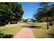 Charming town square featuring brick pathways, green lawns, and a bandstand under a clear blue sky at 546 Orangewood Dr, Dunedin, FL 34698