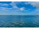 Beautiful waterfront view of sailboats on a sunny day with light clouds and calm waters at 546 Orangewood Dr, Dunedin, FL 34698