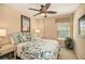 Comfortable bedroom featuring a ceiling fan, a framed painting, and a marine life decorative theme at 5701 S Macdill Ave, Tampa, FL 33611