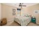 Cozy bedroom with a ceiling fan, neutral walls, carpet floors, and nautical-themed decor at 5701 S Macdill Ave, Tampa, FL 33611