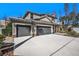 Home showcasing a well-maintained lawn and a spacious three car garage at 5701 S Macdill Ave, Tampa, FL 33611