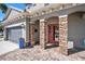 Inviting front entrance with stone columns, a brick paver walkway, and well-manicured landscaping at 5701 S Macdill Ave, Tampa, FL 33611