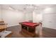 Spacious game room with a pool table, hardwood floors, and ample lighting at 5701 S Macdill Ave, Tampa, FL 33611