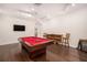 Entertaining game room featuring a pool table, hardwood floors, bar table and mounted tv at 5701 S Macdill Ave, Tampa, FL 33611