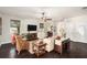 Cozy living room with hardwood floors, a ceiling fan, stylish furnishings, and bright windows at 5701 S Macdill Ave, Tampa, FL 33611