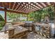 This outdoor kitchen features stone accents, stainless steel appliances and a built-in grill at 5701 S Macdill Ave, Tampa, FL 33611