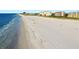 Scenic view of a wide sandy beach with gentle waves and beautiful coastal buildings at 690 Island Way # 802, Clearwater Beach, FL 33767