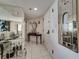 Bright condo foyer with white tile, mirrored walls, decorative table, and front door at 690 Island Way # 802, Clearwater Beach, FL 33767