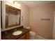 Neutral bathroom featuring granite countertop, vanity, toilet and framed mirror at 1215 Oakhill St, Seffner, FL 33584