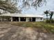Large barn featuring multiple bays, white exterior, situated on a gravel drive at 4156 Mcintosh Rd, Dover, FL 33527