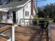Inviting deck area with wood flooring, seating, and a charming white railing at 4156 Mcintosh Rd, Dover, FL 33527