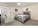 Cozy bedroom featuring a plush armchair, a comfortable bed with a silver frame, and a ceiling fan for added comfort at 804 67Th W St, Bradenton, FL 34209