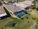 A lovely aerial view of this home's screened in pool, manicured backyard and barrel tile roof at 16122 Cedar Key Dr, Wimauma, FL 33598