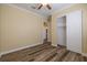 Cozy bedroom with wood floors and a spacious closet, perfect for creating a personalized haven at 16122 Cedar Key Dr, Wimauma, FL 33598