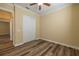 Neutral bedroom featuring wood floors, a ceiling fan, closet, and fresh paint, offering a serene space at 16122 Cedar Key Dr, Wimauma, FL 33598