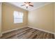 Bright bedroom with wood floors and a large window, ready for personalization and comfort at 16122 Cedar Key Dr, Wimauma, FL 33598