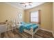 Cozy bedroom with a bright window, comfortable bed, and a desk, perfect for a relaxing retreat at 16122 Cedar Key Dr, Wimauma, FL 33598
