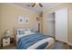 Well-lit bedroom with wood floors, fresh paint, closet, and comfortable bed, designed for restful sleep at 16122 Cedar Key Dr, Wimauma, FL 33598