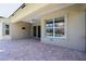 Spacious outdoor patio with tile flooring, view of the swimming pool and green foliage at 16122 Cedar Key Dr, Wimauma, FL 33598