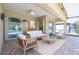 Inviting patio with comfortable seating and a view of the pool and outdoor landscape at 16122 Cedar Key Dr, Wimauma, FL 33598