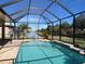 Take a dip in this screened enclosed pool overlooking a manicured lawn and peaceful pond at 16122 Cedar Key Dr, Wimauma, FL 33598