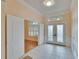 Elegant foyer with tile flooring and decorative glass double doors leading to a study at 25622 Ferdinand Ct, Wesley Chapel, FL 33544