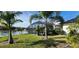 An inviting screened pool with lush landscaping overlooking a serene lake at 25622 Ferdinand Ct, Wesley Chapel, FL 33544