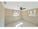 Bedroom featuring tile floors, ceiling fan and windows offering plenty of natural light at 8839 W Millpoint Rd, Riverview, FL 33578