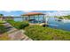 View of a private boat dock with lift on a sunny day surrounded by lush foliage at 8839 W Millpoint Rd, Riverview, FL 33578