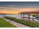 Backyard view of covered boat dock on the water with lush greenery at 8839 W Millpoint Rd, Riverview, FL 33578