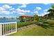 Waterfront property featuring a private dock with a boat lift, lush landscaping, and beautiful waterfront views at 8839 W Millpoint Rd, Riverview, FL 33578