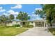 Charming single-story home featuring a well-manicured lawn and beautiful landscaping, perfect for outdoor living at 8839 W Millpoint Rd, Riverview, FL 33578