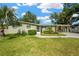 Charming home boasts a beautifully landscaped front yard with lush greenery and a welcoming walkway at 8839 W Millpoint Rd, Riverview, FL 33578