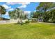 Home with well-kept lawn and beautiful landscaping, including mature trees and a charming walkway to the entrance at 8839 W Millpoint Rd, Riverview, FL 33578
