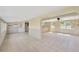 A bright living room boasting tile floors, a ceiling fan, and expansive windows, offering ample natural light at 8839 W Millpoint Rd, Riverview, FL 33578