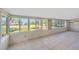 Sunroom featuring tile floors, multiple windows and water views at 8839 W Millpoint Rd, Riverview, FL 33578