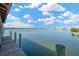 Waterfront view from the private dock showcasing the serene open water and nearby waterfront community at 8839 W Millpoint Rd, Riverview, FL 33578