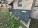 Side of home featuring an air conditioning unit, window, and view of the partially fenced backyard at 916 123Rd Ave, Tampa, FL 33612